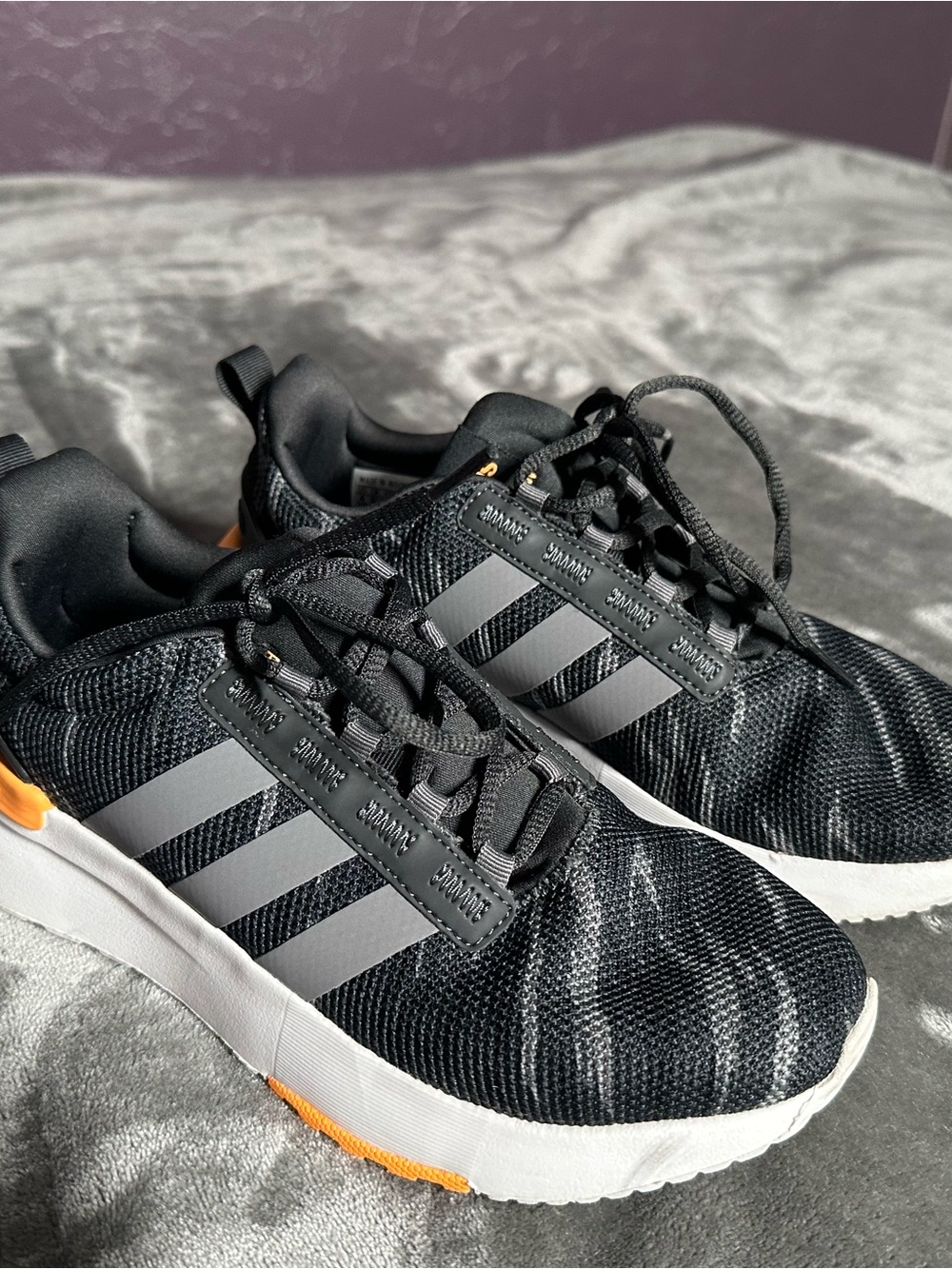 Black/gray Adidas sneakers with orange detail 🧡